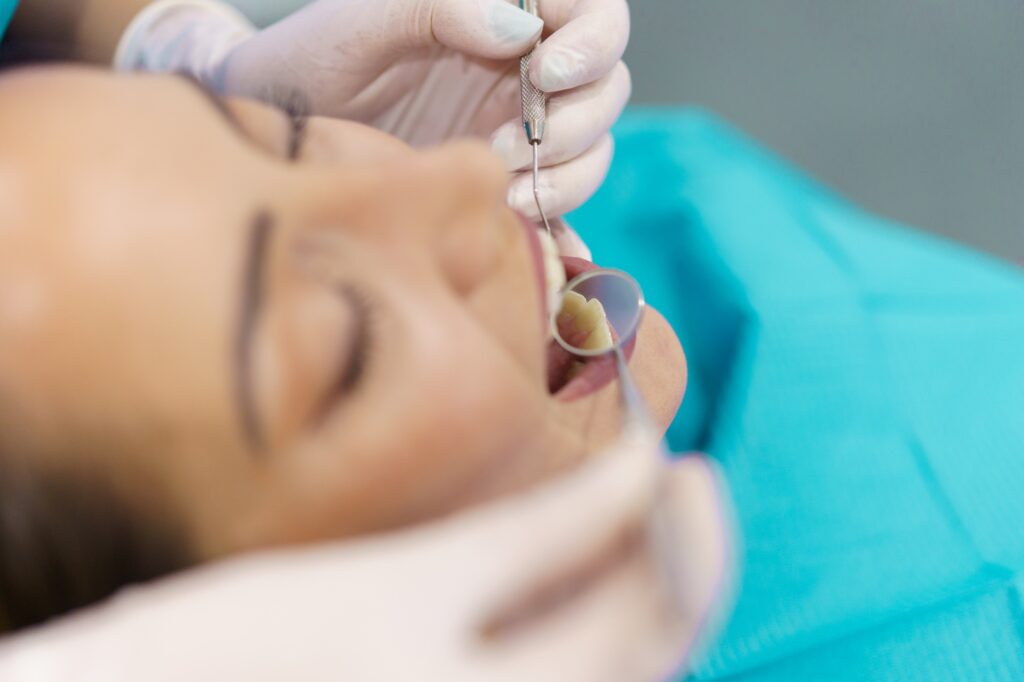 Dentist examining a patient’s gums during a periodontal checkup in Alexandria, VA