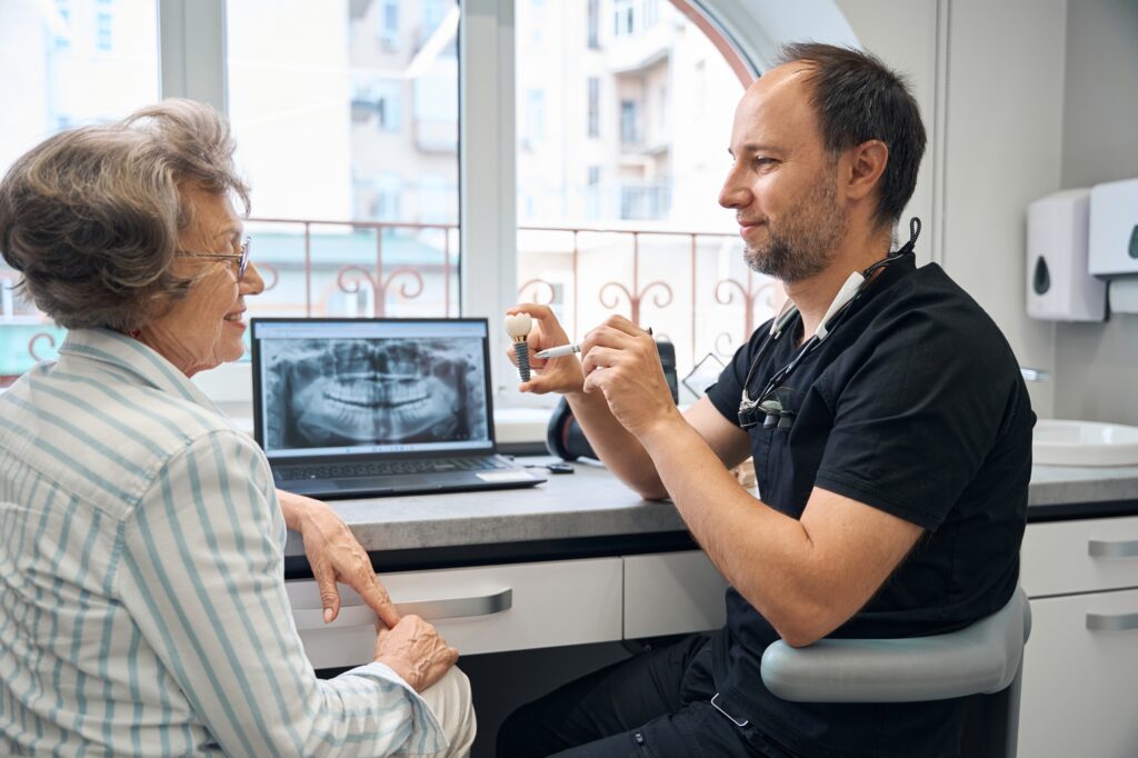 Dentist discussing dental implant treatment options with a patient in Alexandria VA