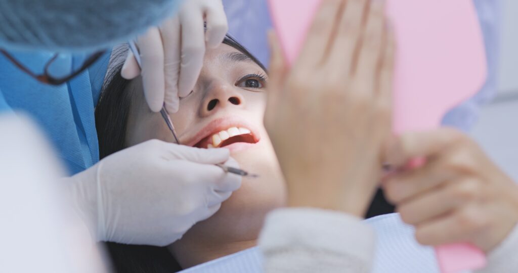 Dentist examining a patient's gums for signs of gingivitis and periodontal disease in Alexandria, VA